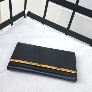Genuine 1950s black leather clutch with gold accents